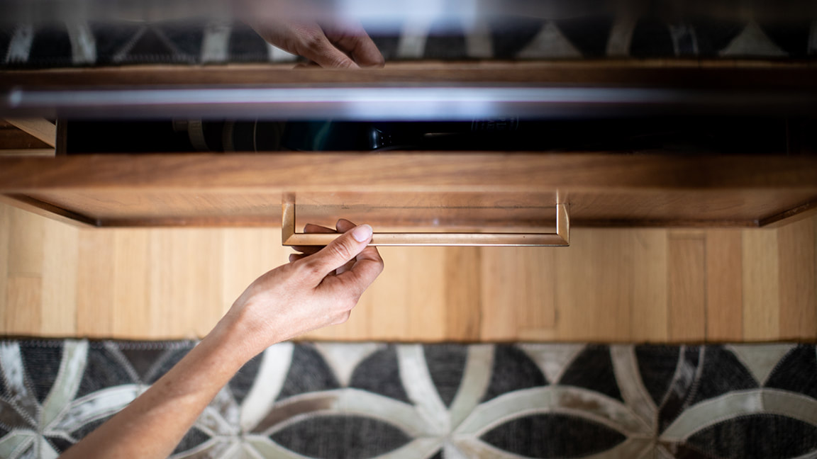 Walnut cabinet drawers with modern brass hardware