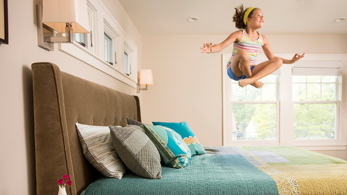 Girl Jumping on Bed