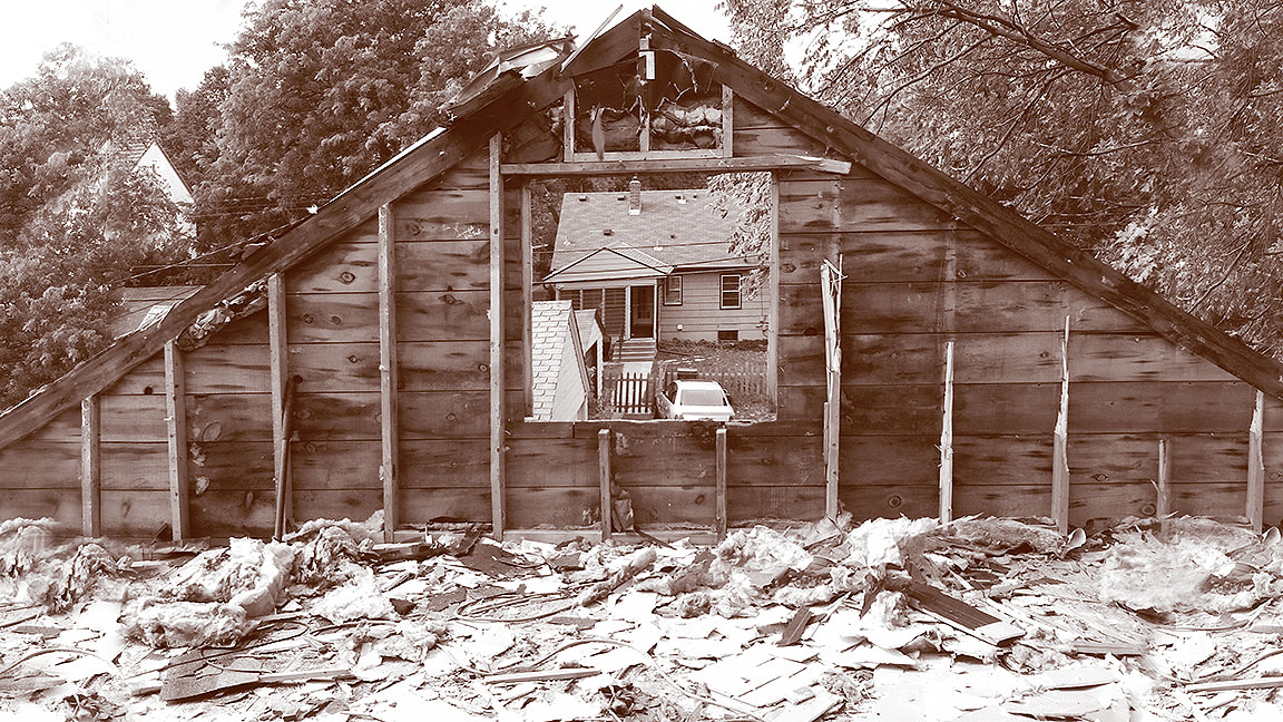 Free-standing gable end wall during demolition