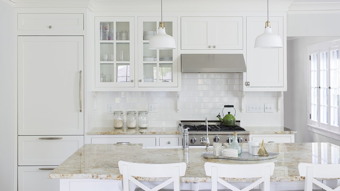 Traditional white kitchen with marble countertops
